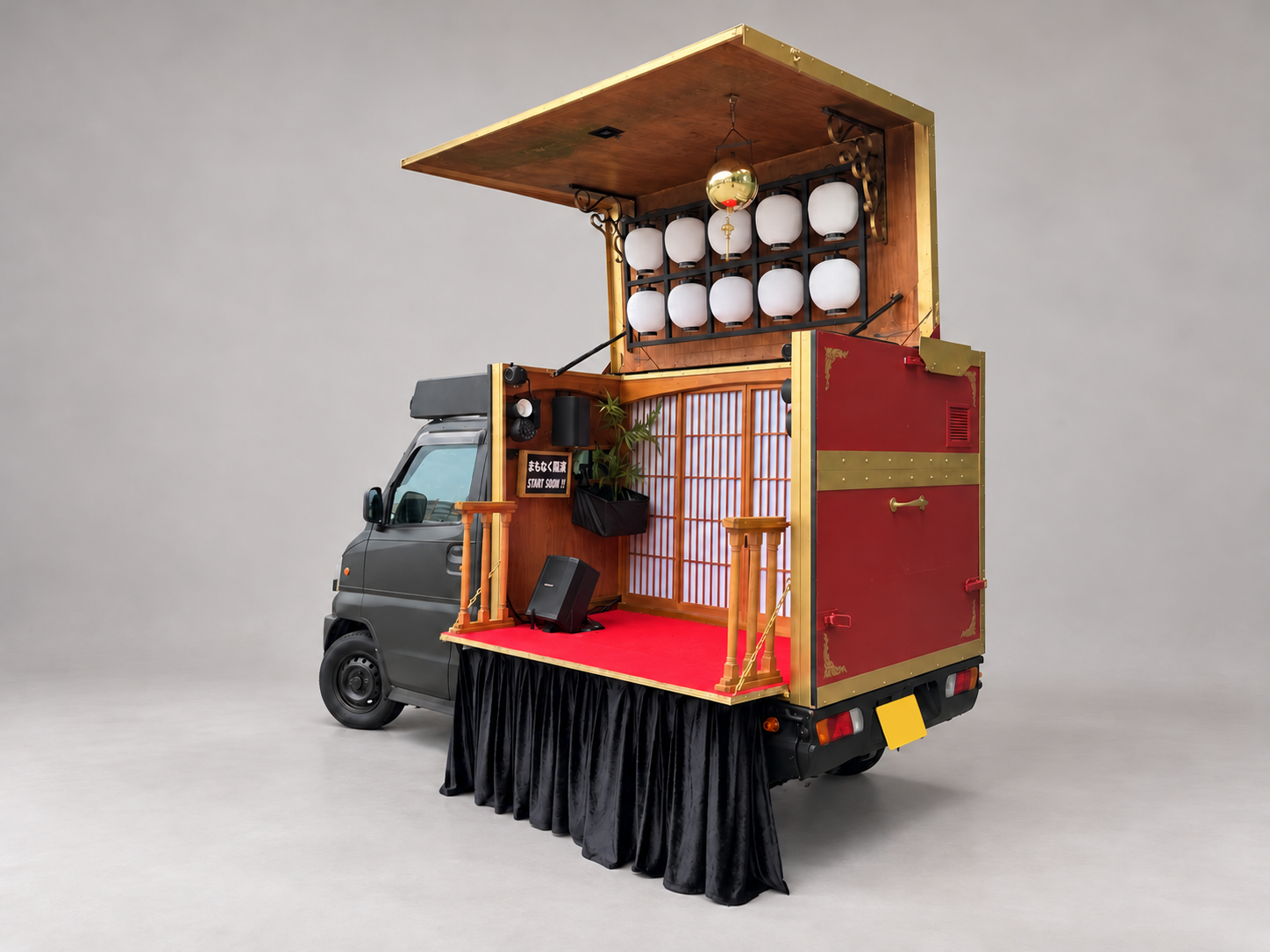 The open TAKARABAKO treasure-box stage with red flooring and lanterns, viewed at an angle