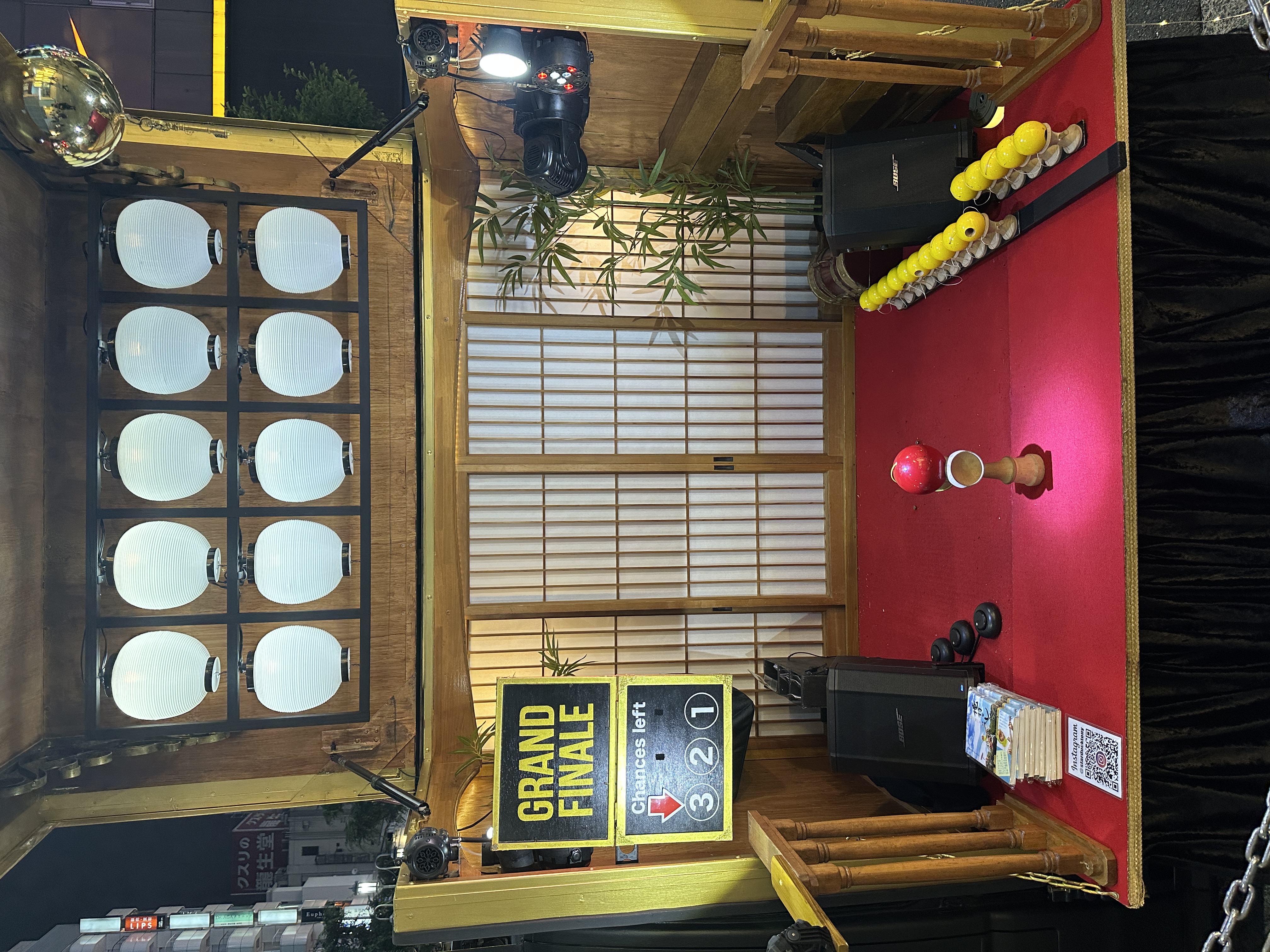 TAKARABAKO at night, with lanterns, illuminated red flooring and kendama