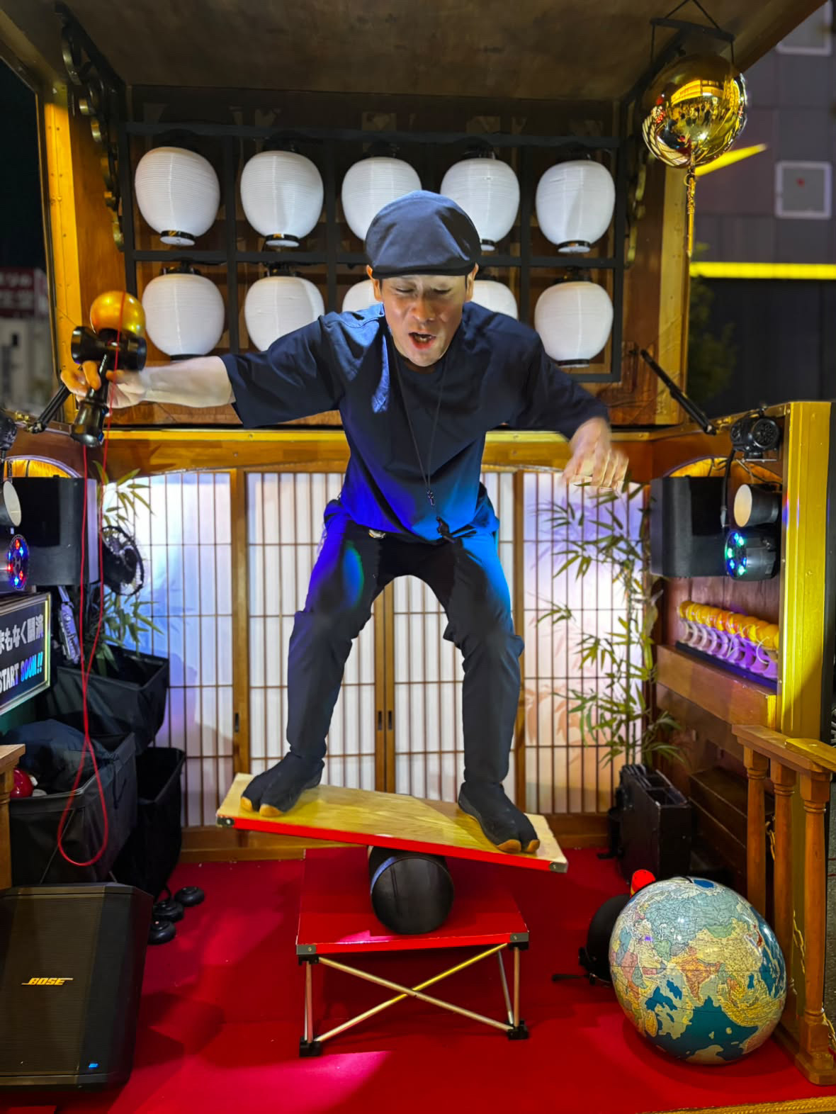 Starduck Tony performing kendama on a roller balance board on the TAKARABAKO stage